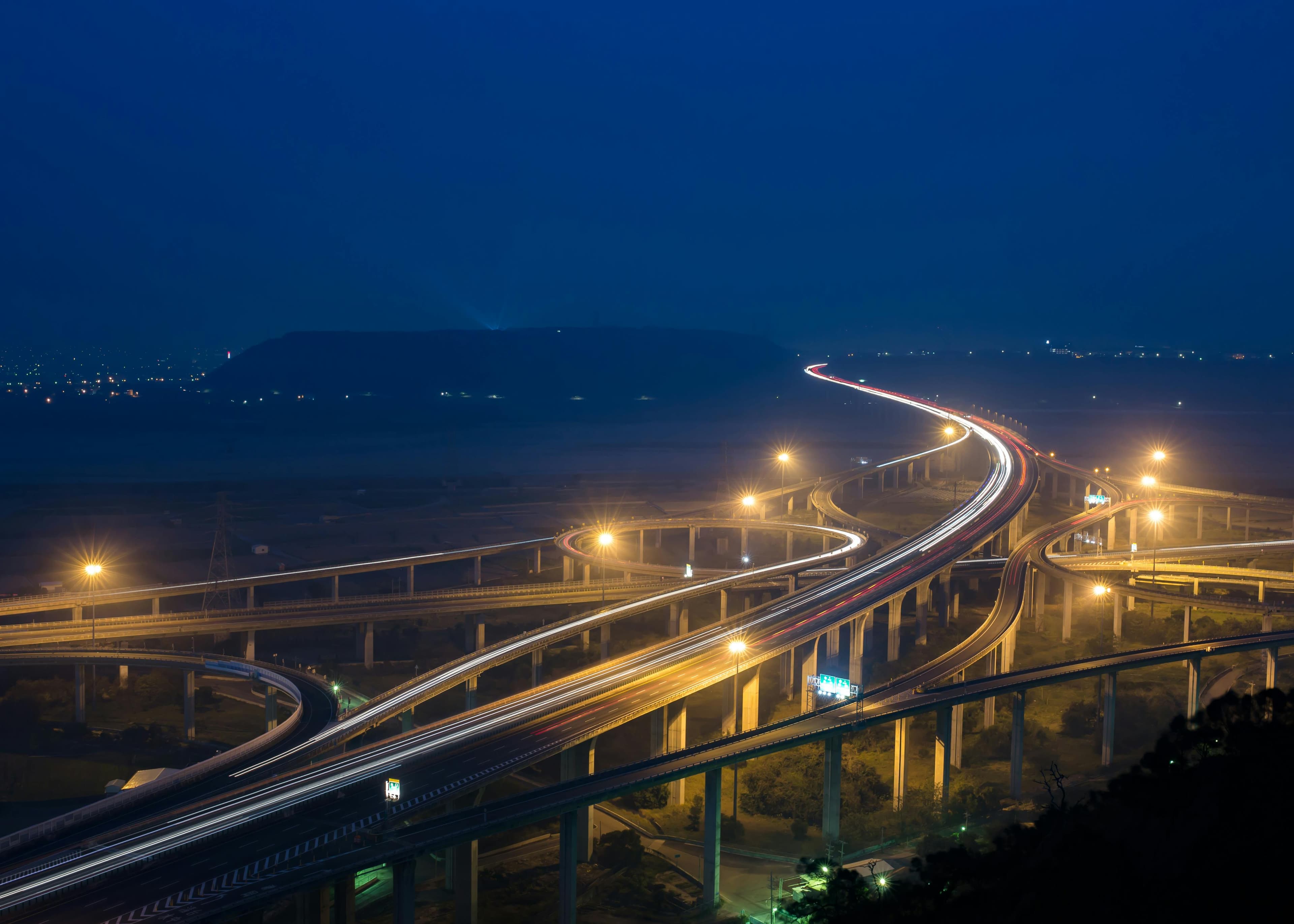 Critical infrastructure at night: an interchange with trails of light.